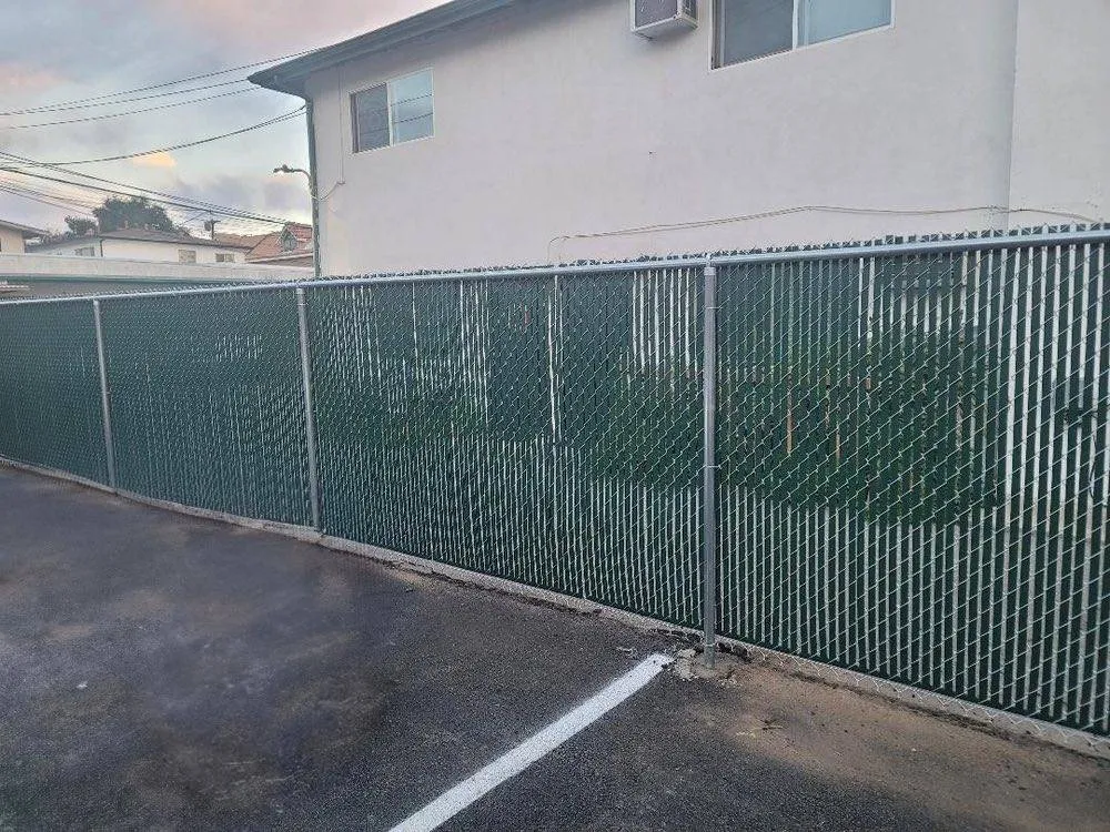 Chain link fence with green privacy slats