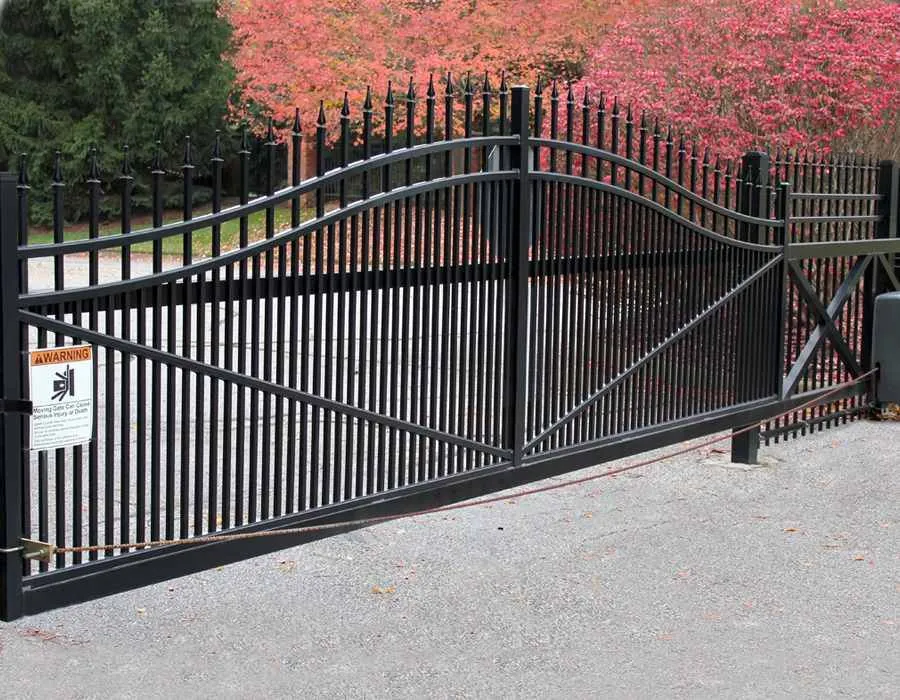 Spear-top metal fence with arched driveway gate